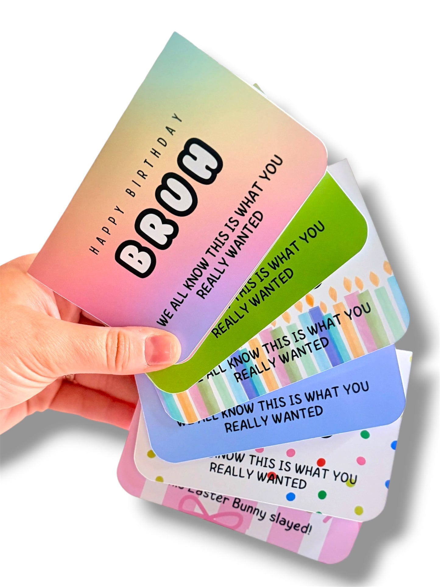 Hand holding a stack of colorful cards with humorous text