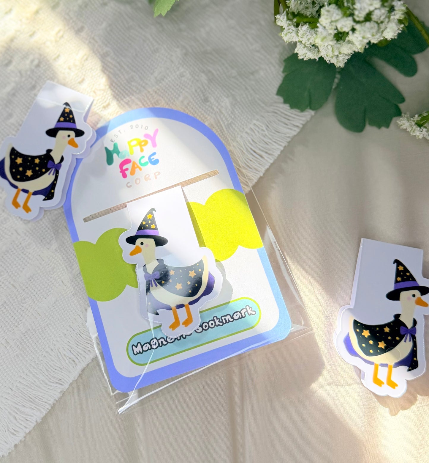 silly goose magnetic bookmark wearing a black and purple magician outfit