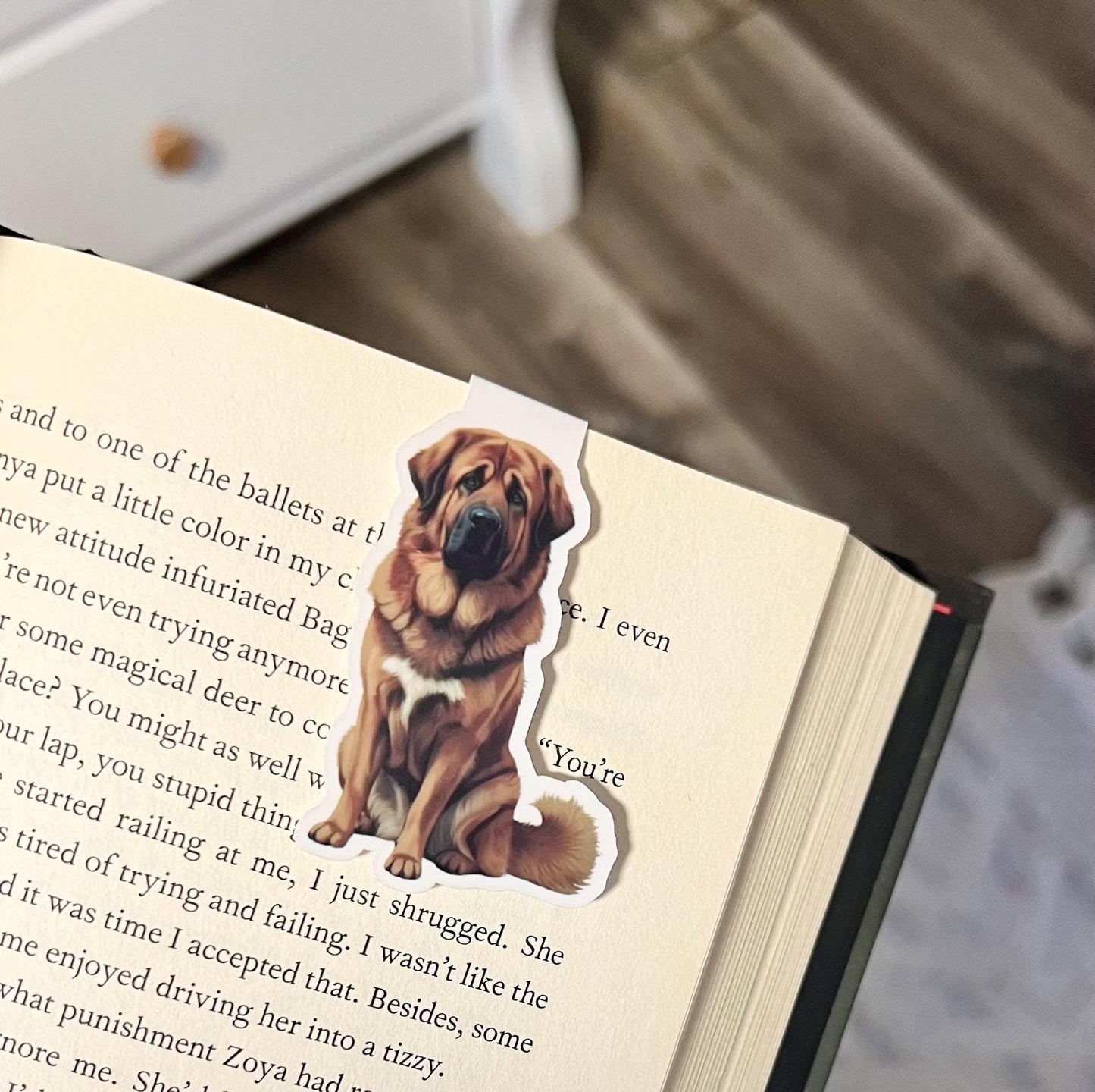 Magnetic bookmark of a semi realistic, cartoon style brown Tibetan mastiff dog