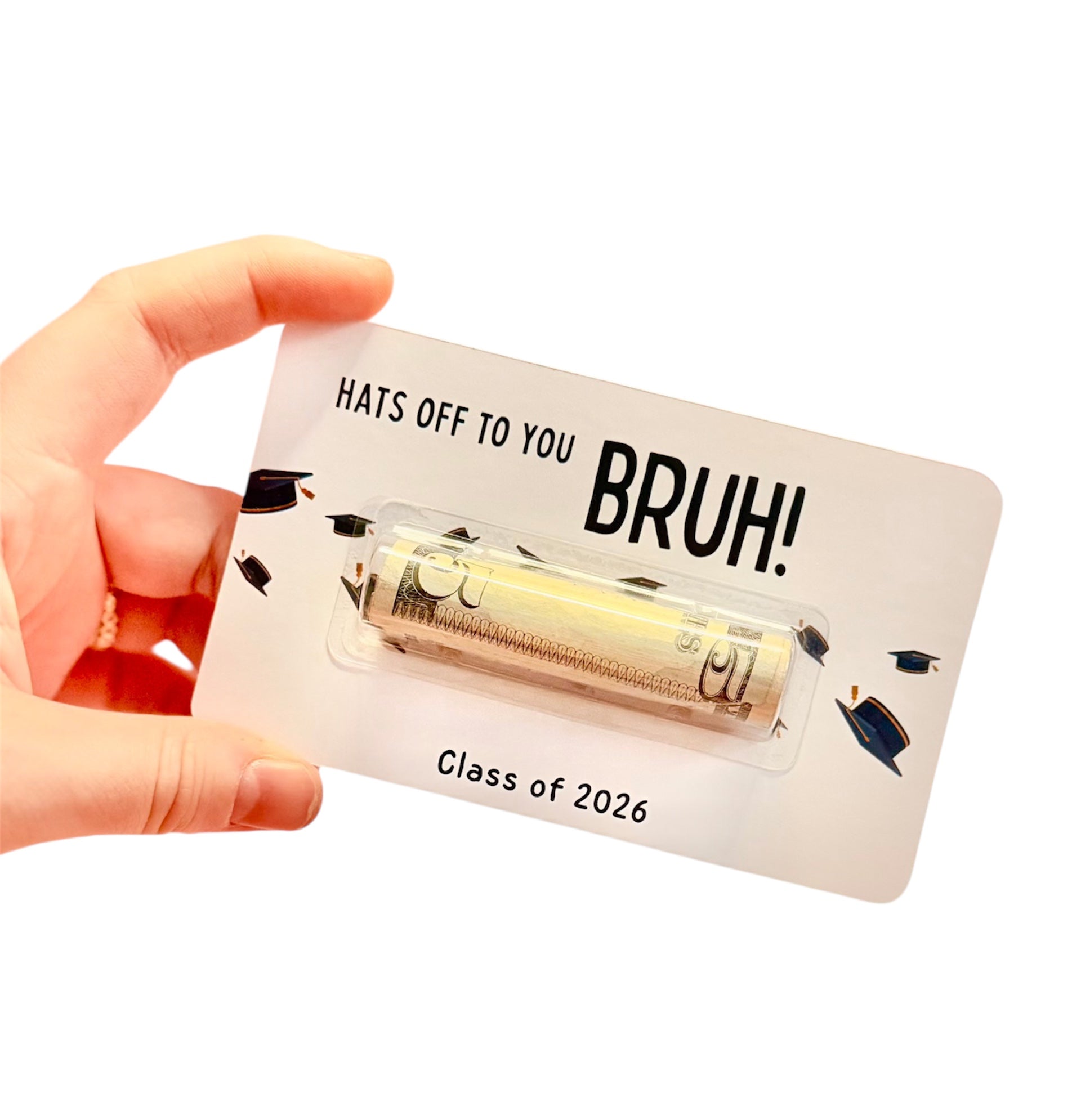 Hand holding a card with 'Hats off to you BRUH!' text and a small item, on a white background