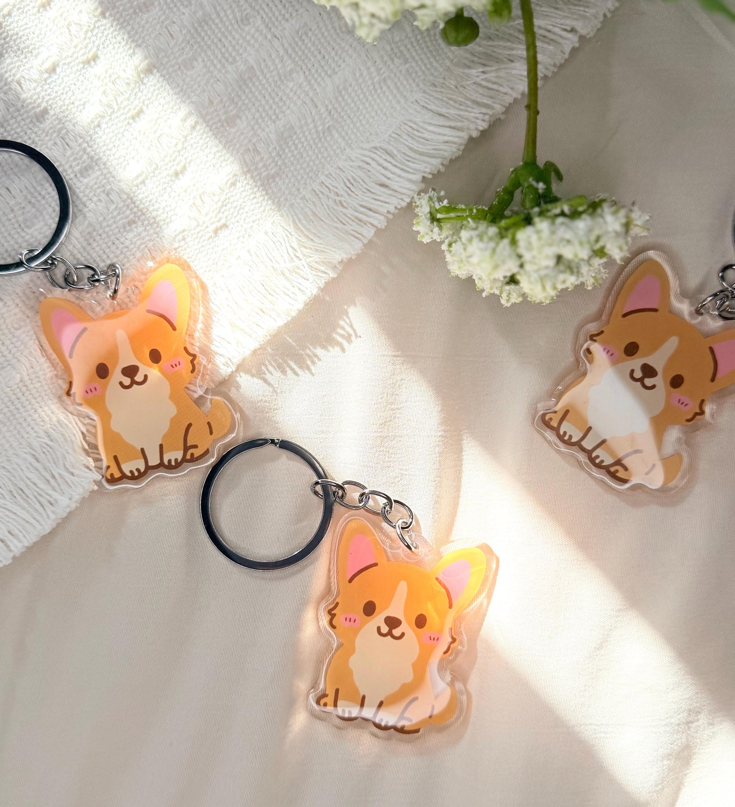 An acrylic keychain of a Kawaii style corgi dog