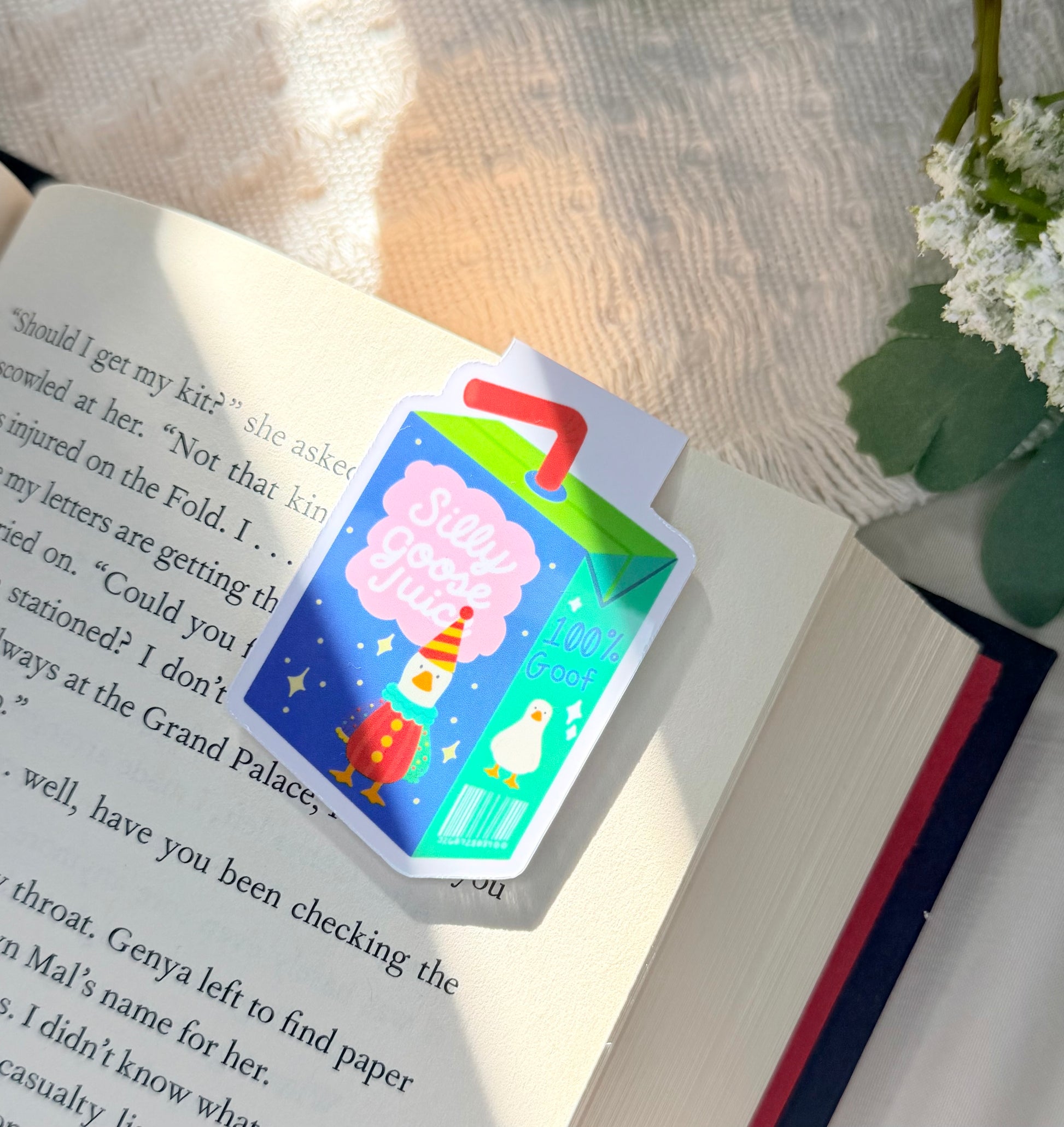 Magnetic bookmark of a Blue and green silly goose juice box. Goose is wearing a colorful clown costume