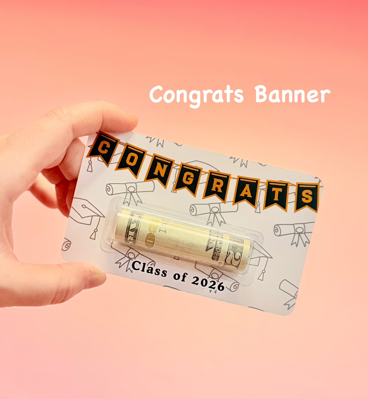 Hand holding a card with 'Congrats Banner' design on a pink background
