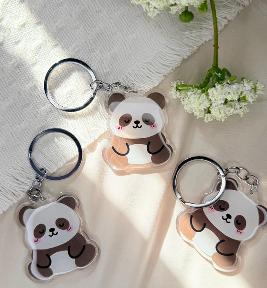An acrylic keychain of a Kawaii style panda bear