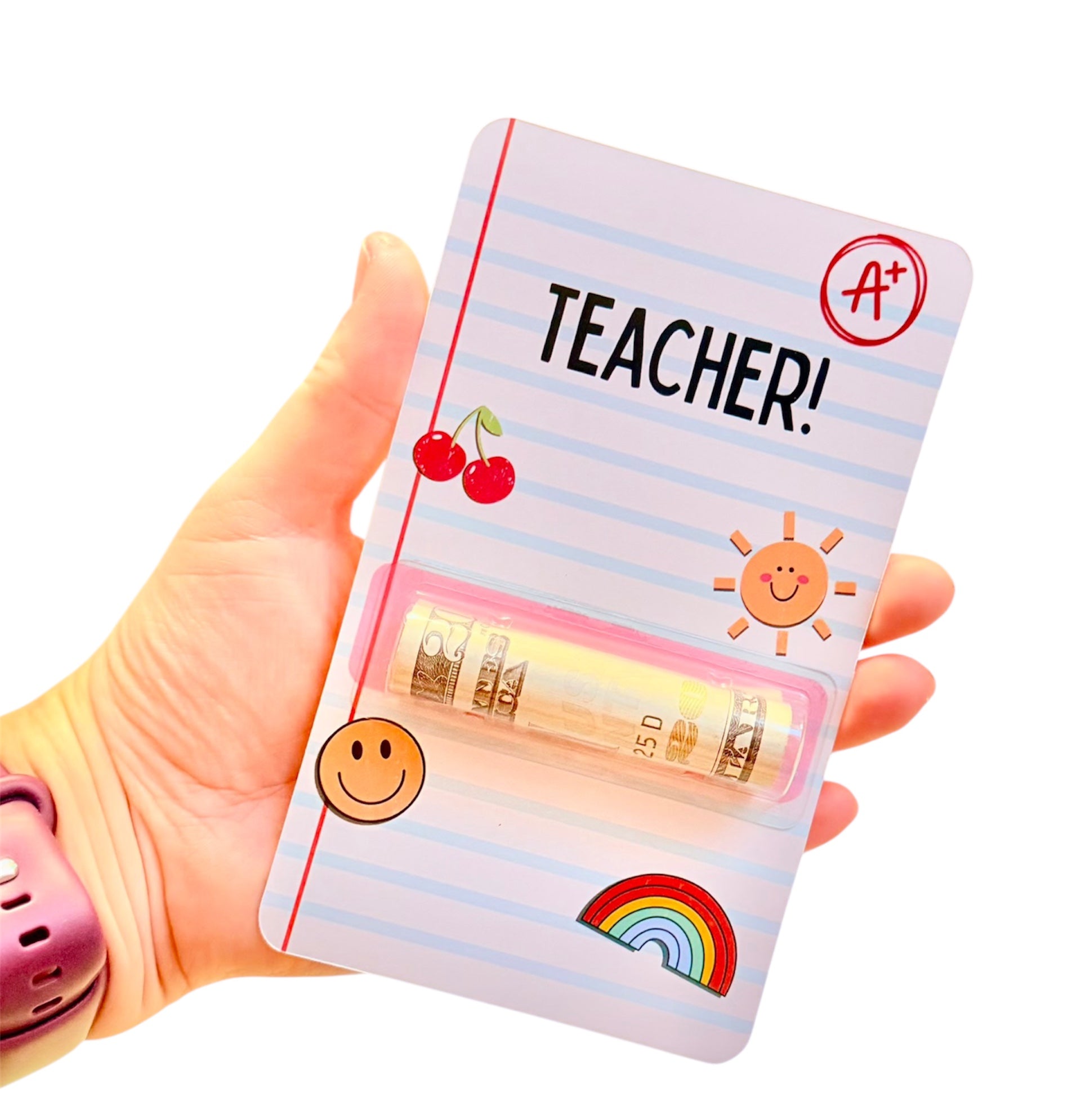 Hand holding a small notebook with 'TEACHER!' text and colorful designs on a white background