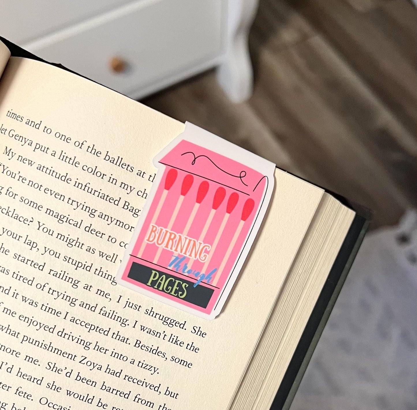 Magnetic bookmark of a book of matches that says burning through pages