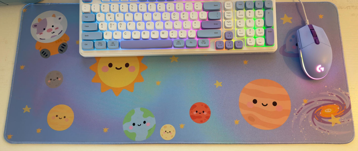 Keyboard and mouse on a colorful space-themed mouse pad