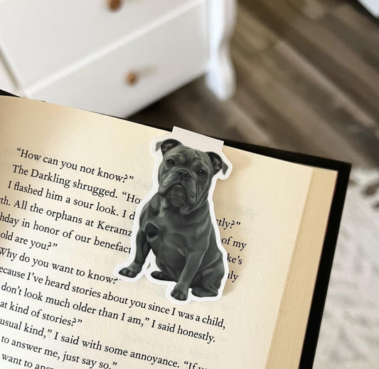 A magnetic bookmark of a semi realistic, cartoon style, dark gray bulldog