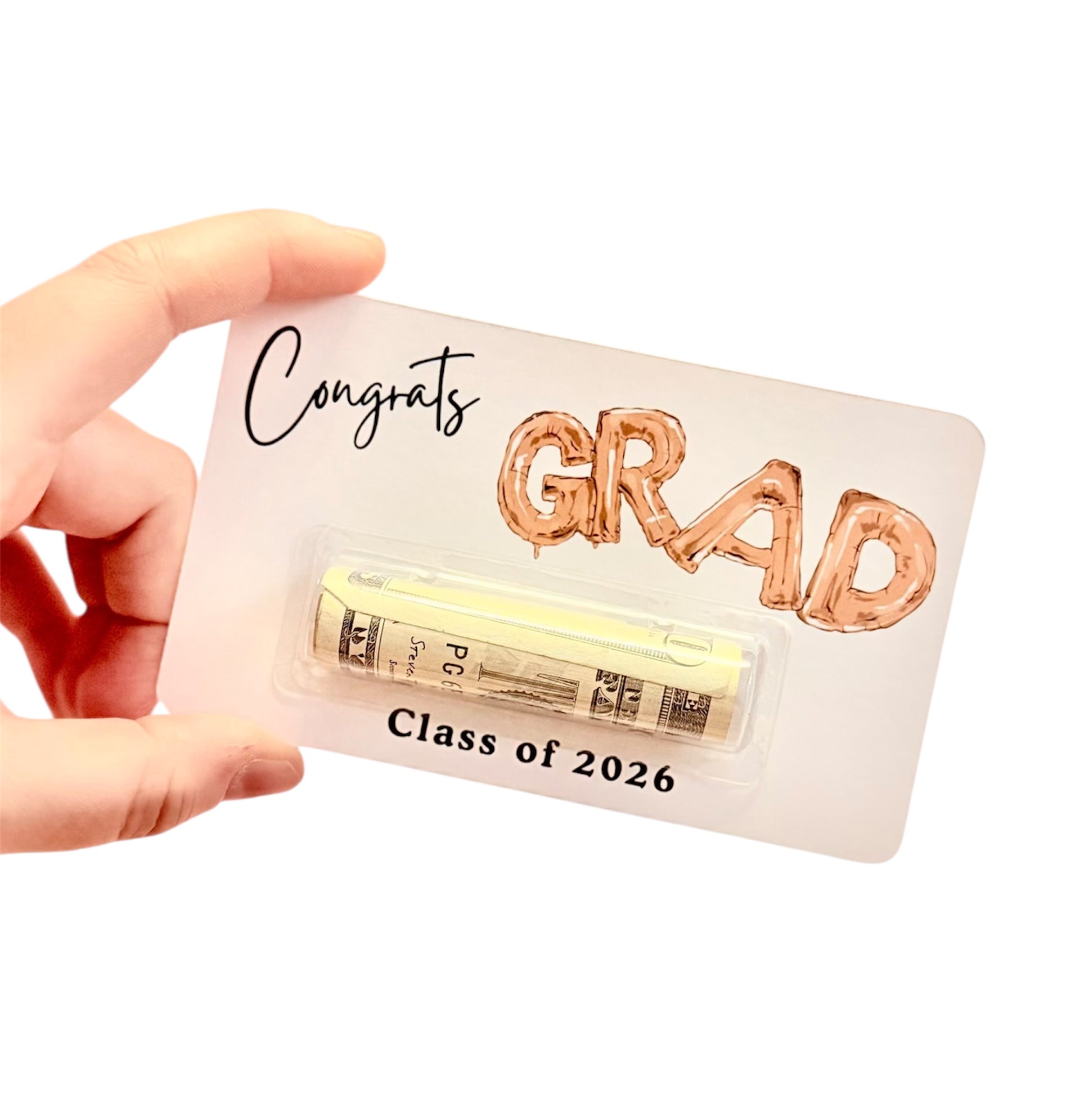 Graduation-themed card with 'Congrats GRAD' text and a small stack of money, held by a hand.
