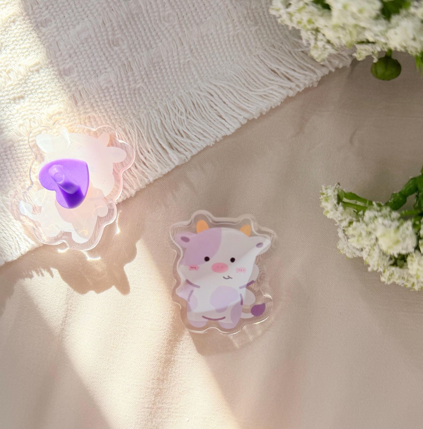 An acrylic pen of a Kawaii style purple spotted cow
