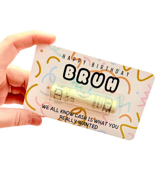 Hand holding a small gift card with 'Happy Birthday Bruh' text and colorful design.