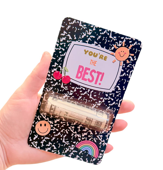Hand holding a small gift bag with 'You're the Best!' text and colorful designs.