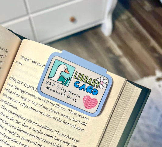 A magnetic bookmark that is a silly goose library card with a picture of a cartoon goose and purple outline