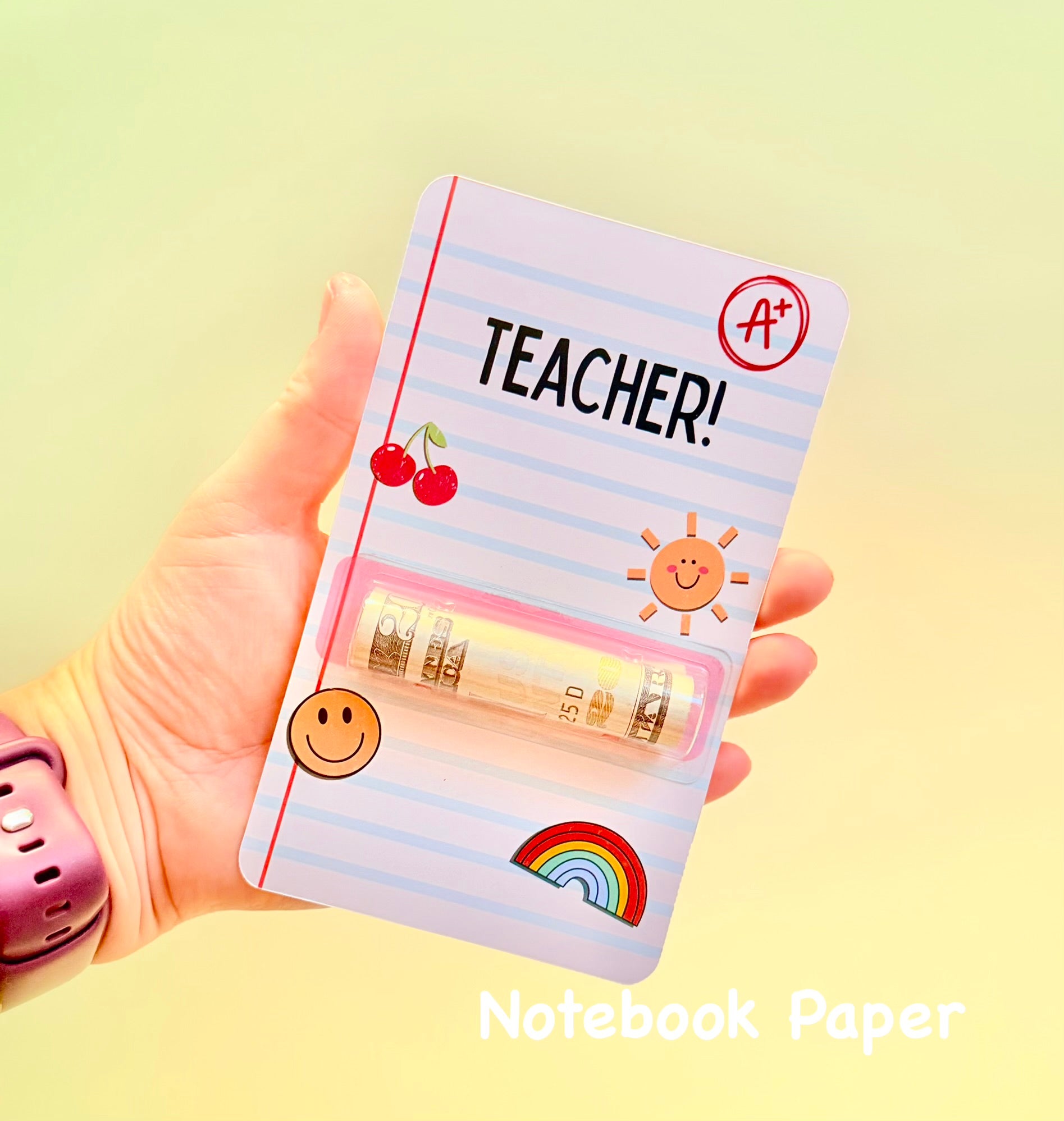 Notebook paper style card with colorful designs and text held by a hand on a yellow background