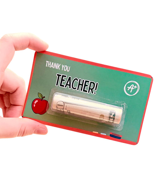 Card with a pen and 'Thank you Teacher!' text, held by a hand on a white background