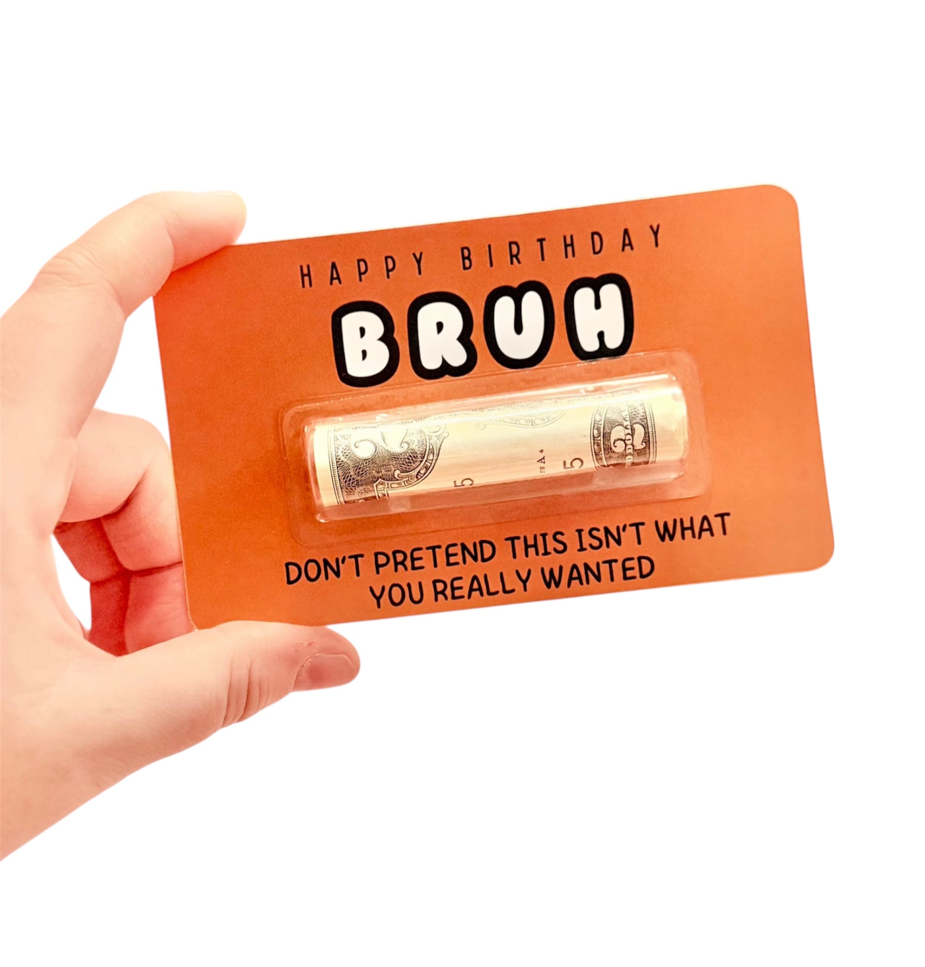 Orange birthday card with money inside, held by a hand on a white background