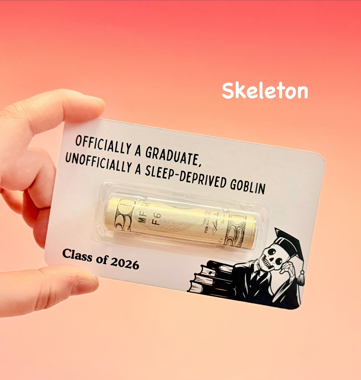 Graduation-themed card with a skeleton design and text on a pink background