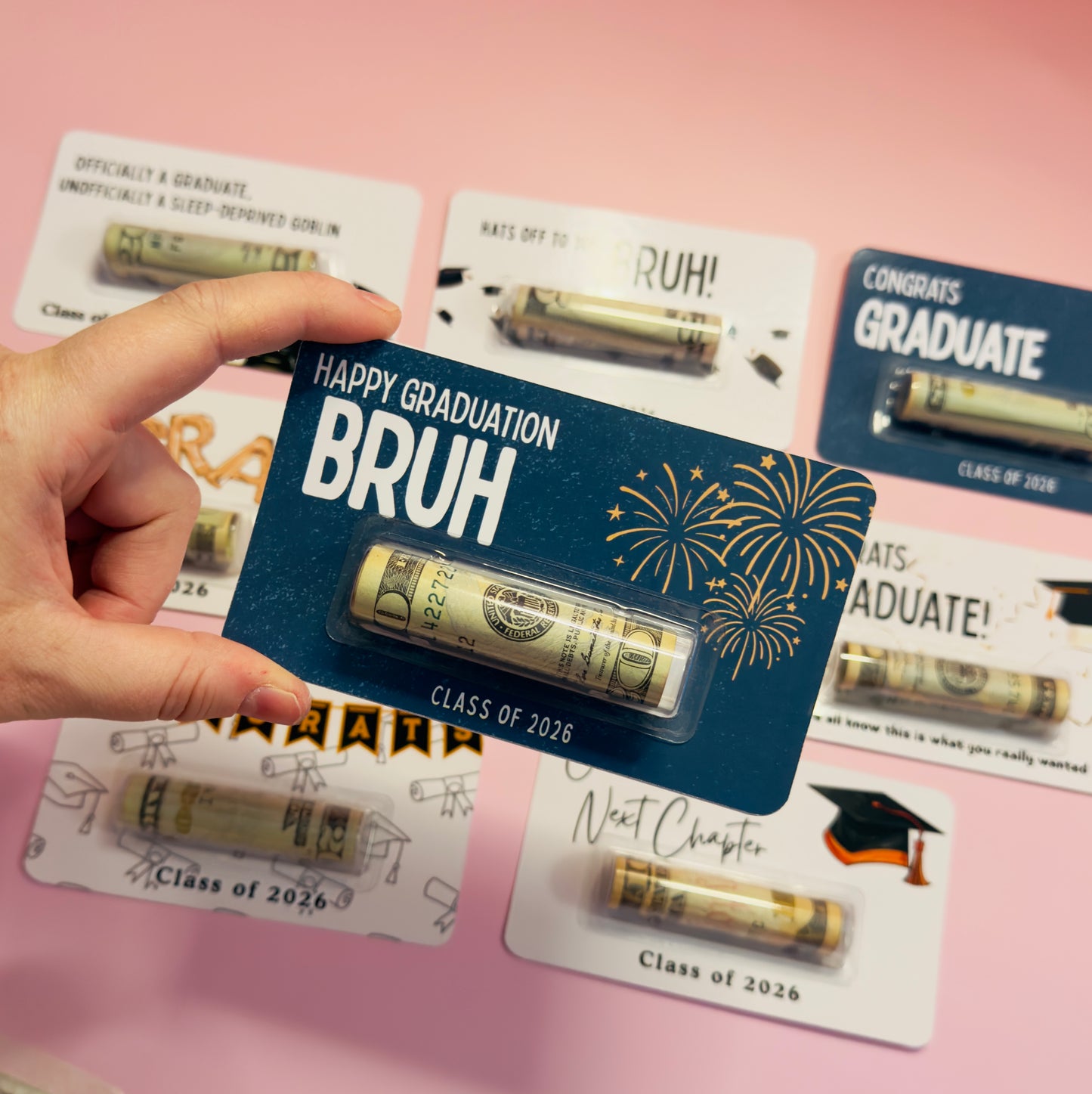 Graduation-themed gift card with 'Happy Graduation Bruh' text and gold tube on a pink background.