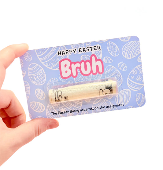 Hand holding a novelty easter brush with packaging that says 'Happy Easter Bruh'.