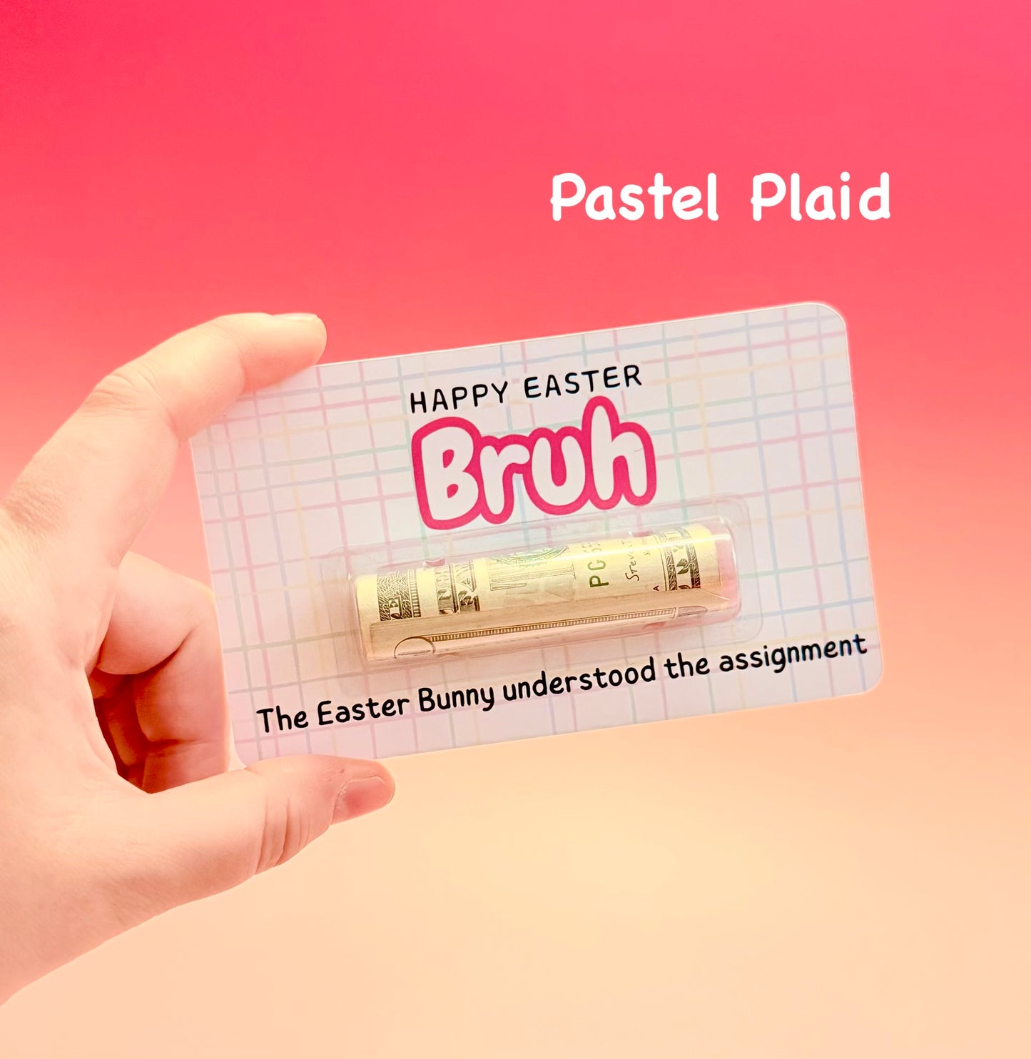 Hand holding a small tube of lipstick with a 'Happy Easter Bruh' card on a pink background