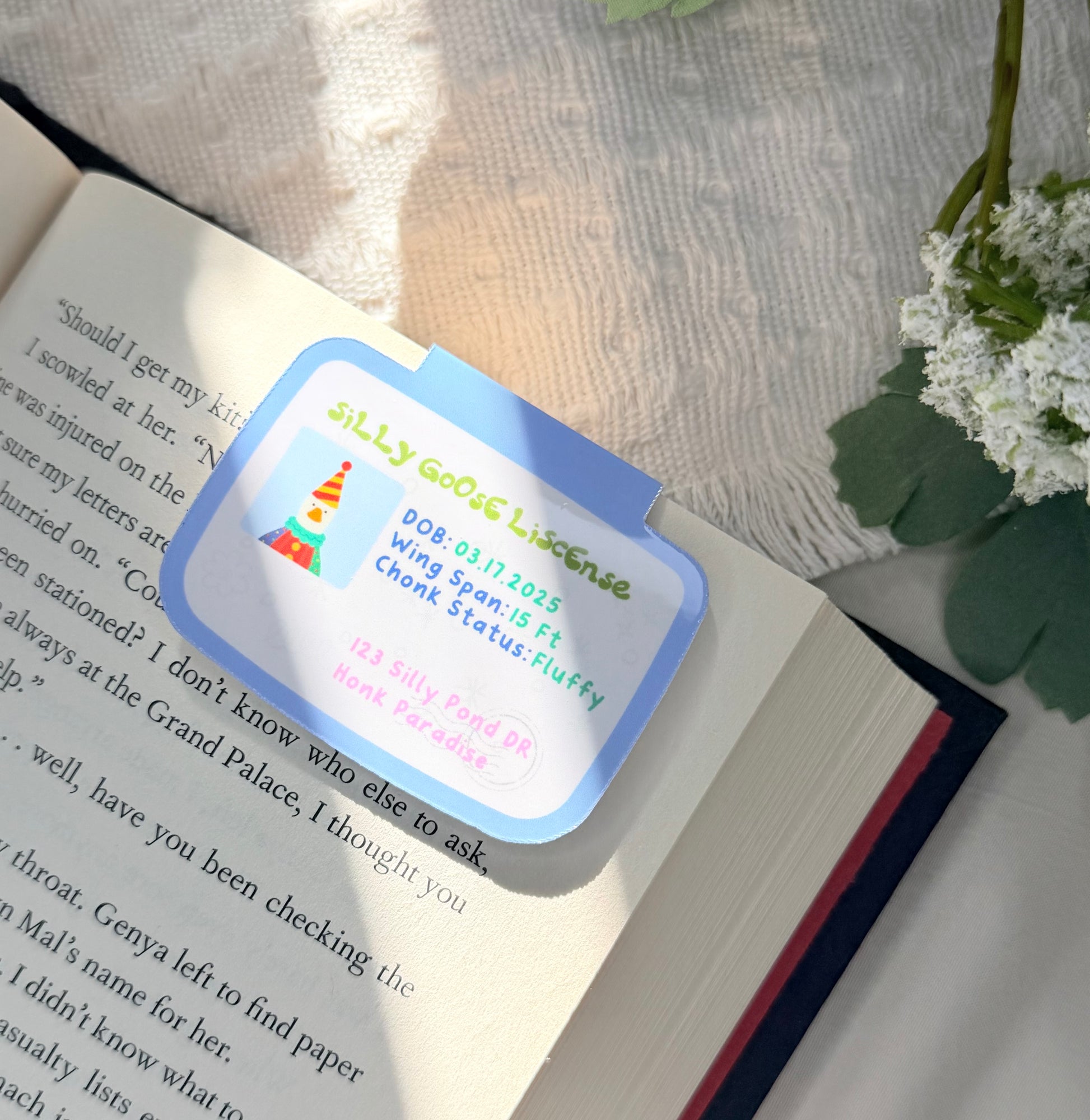 A magnetic bookmark of a silly goose license with a picture of a goose wearing a colorful clown costume
