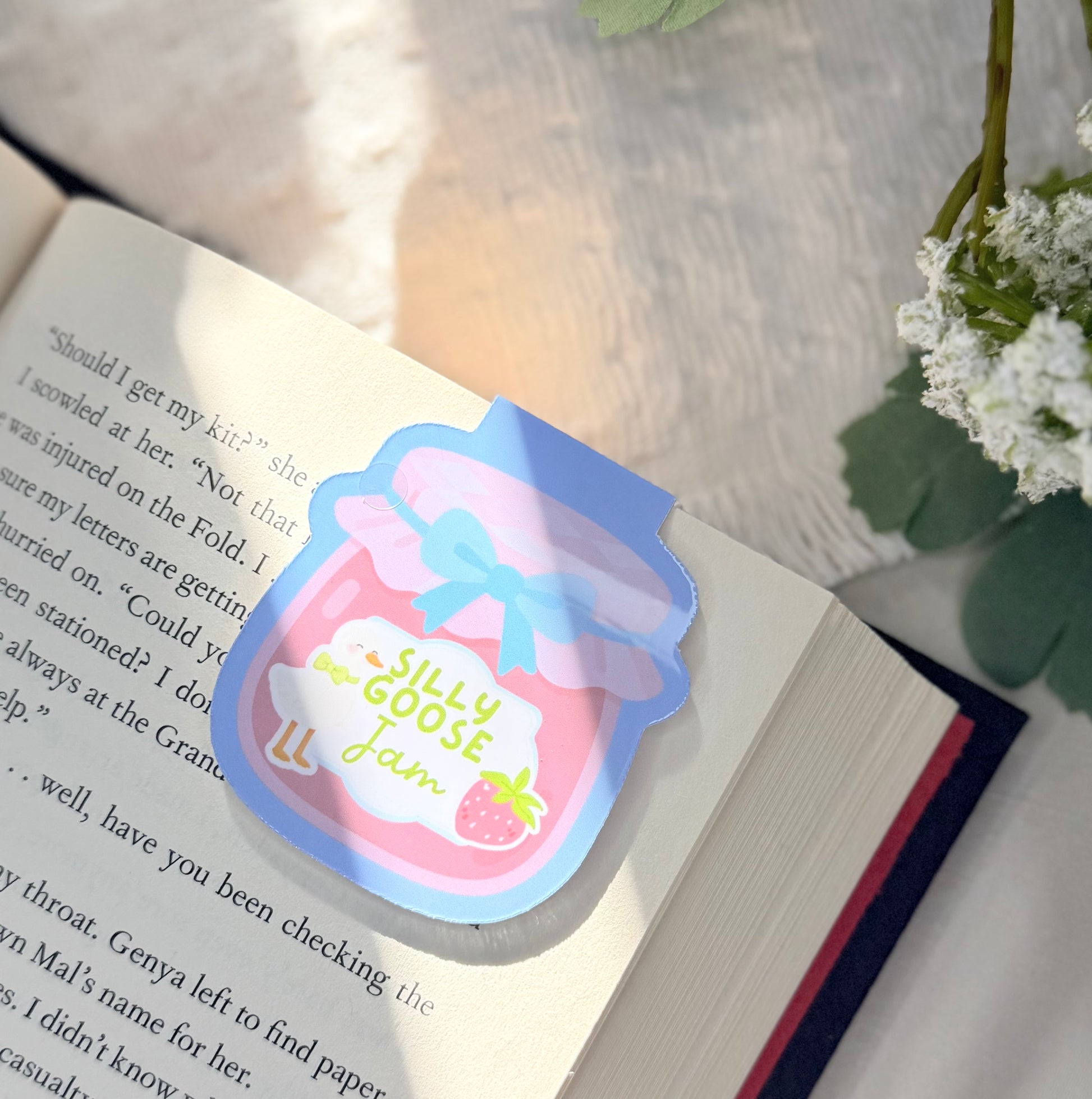 A magnetic bookmark of silly goose jam in a pink strawberry jam jar