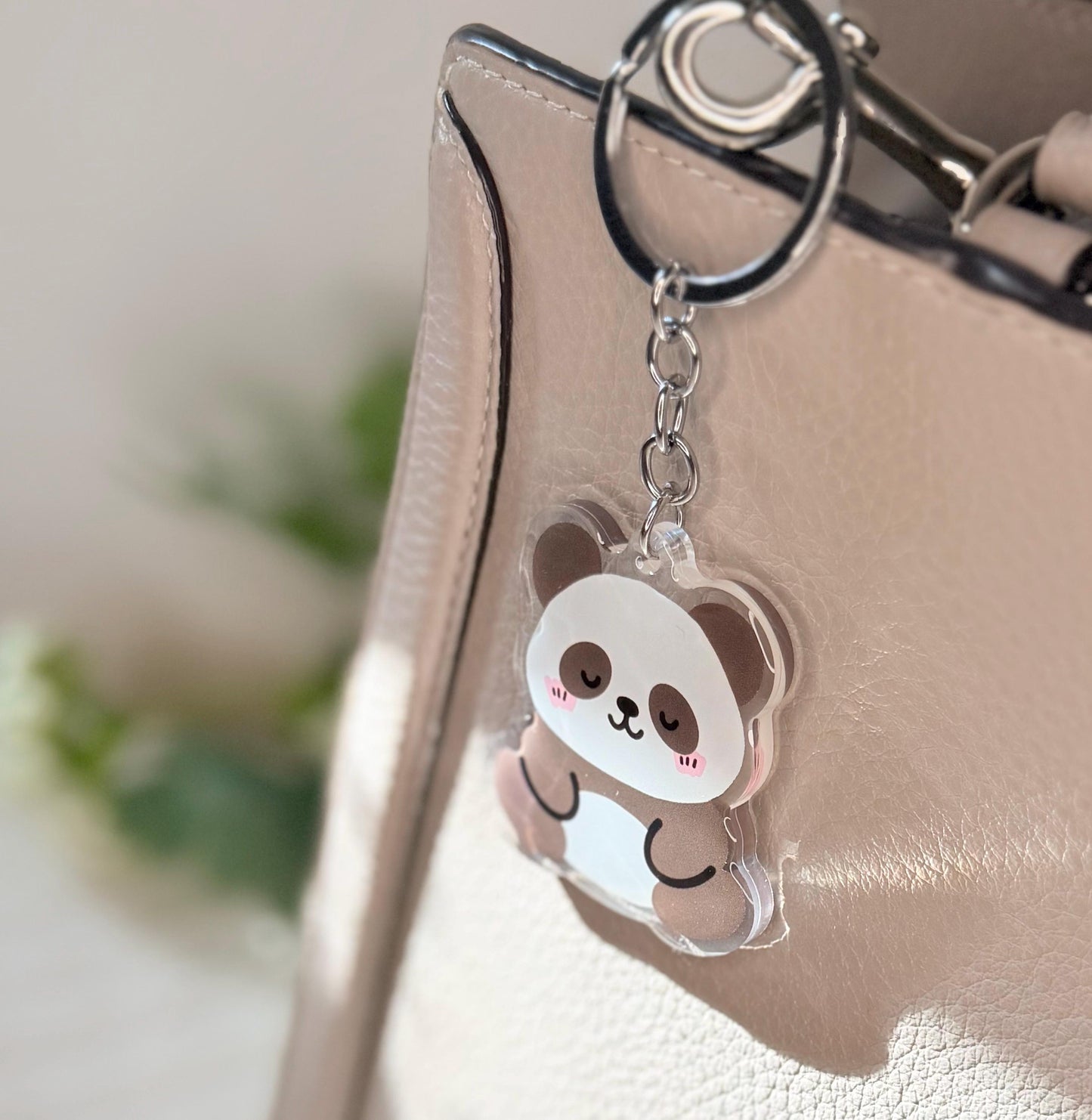 The Panda Bear keychain displayed on a purse