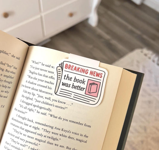 A magnetic bookmark of a cartoon style newspaper that says breaking news the book was better
