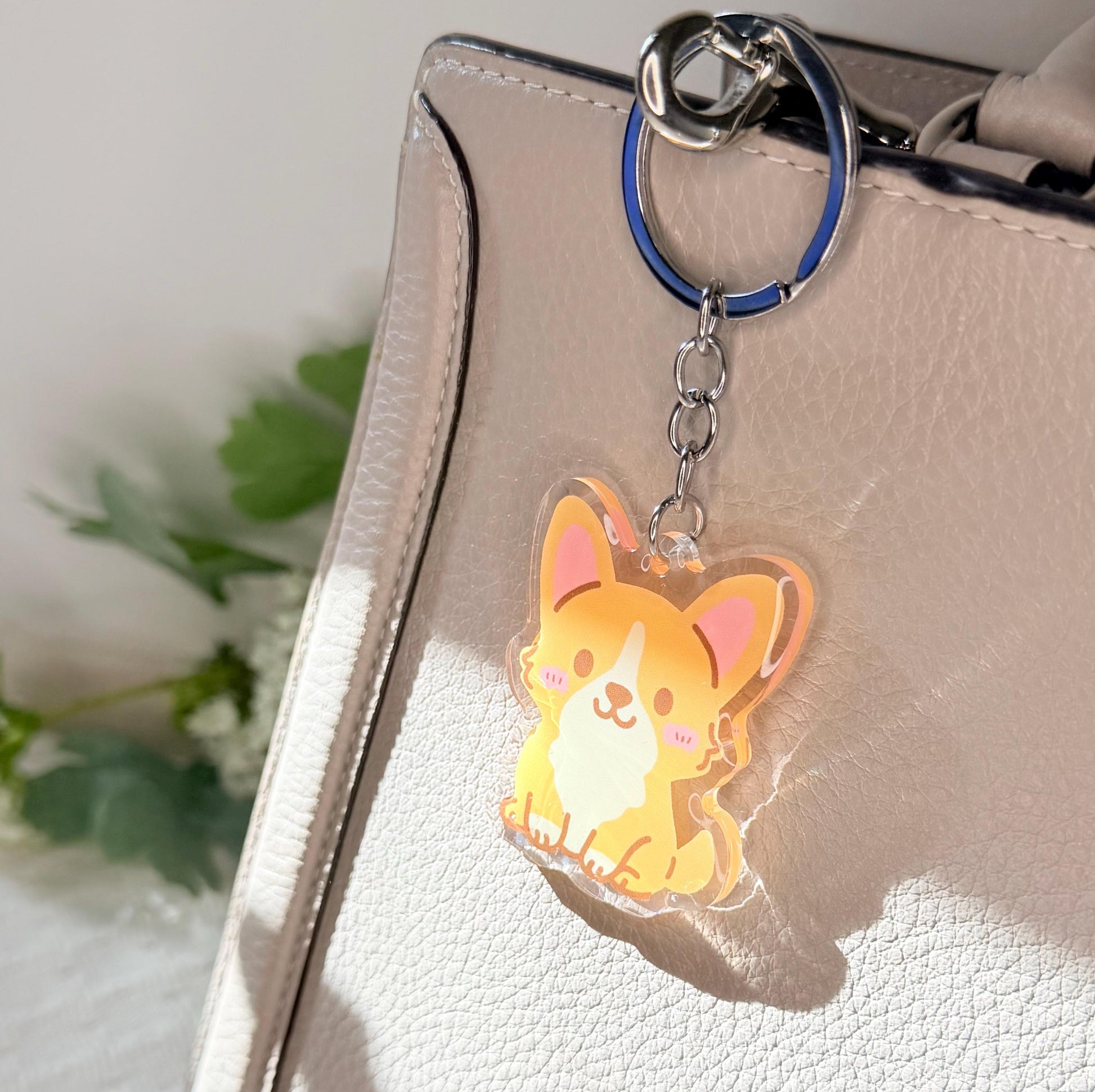 The corgi dog keychain displayed on a purse