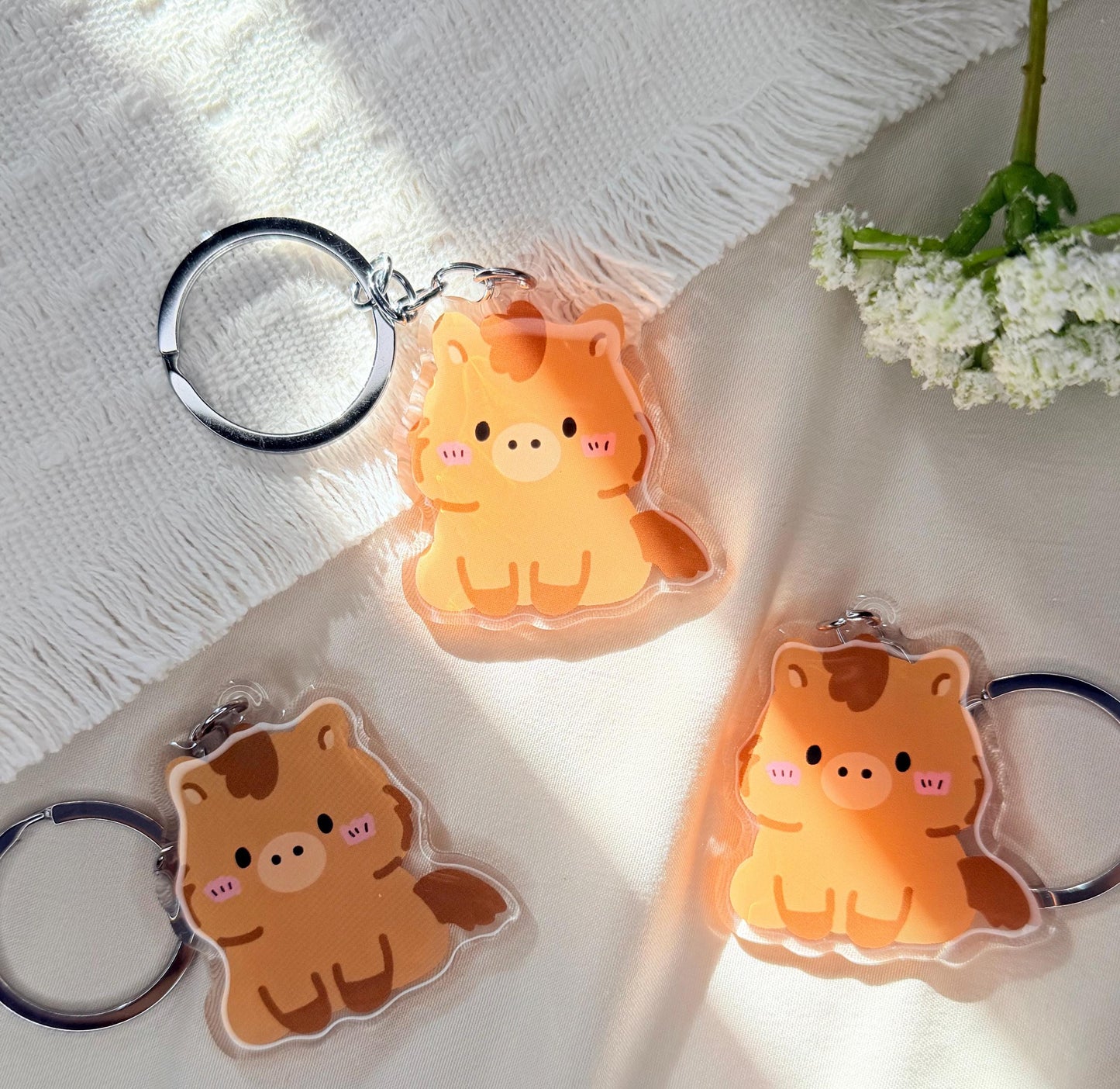 An acrylic keychain of a Kawaii style brown horse