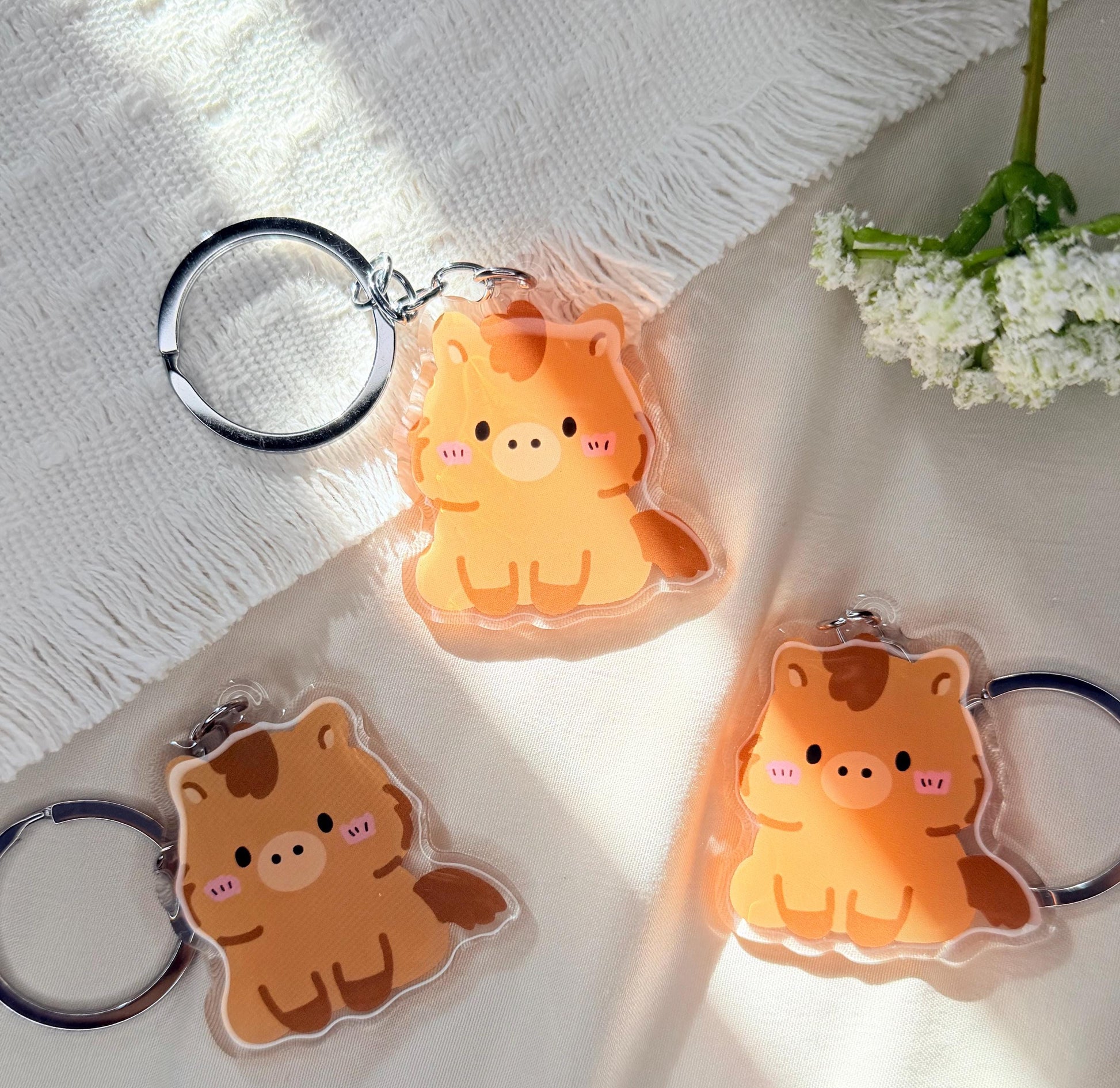 An acrylic keychain of a Kawaii style brown horse