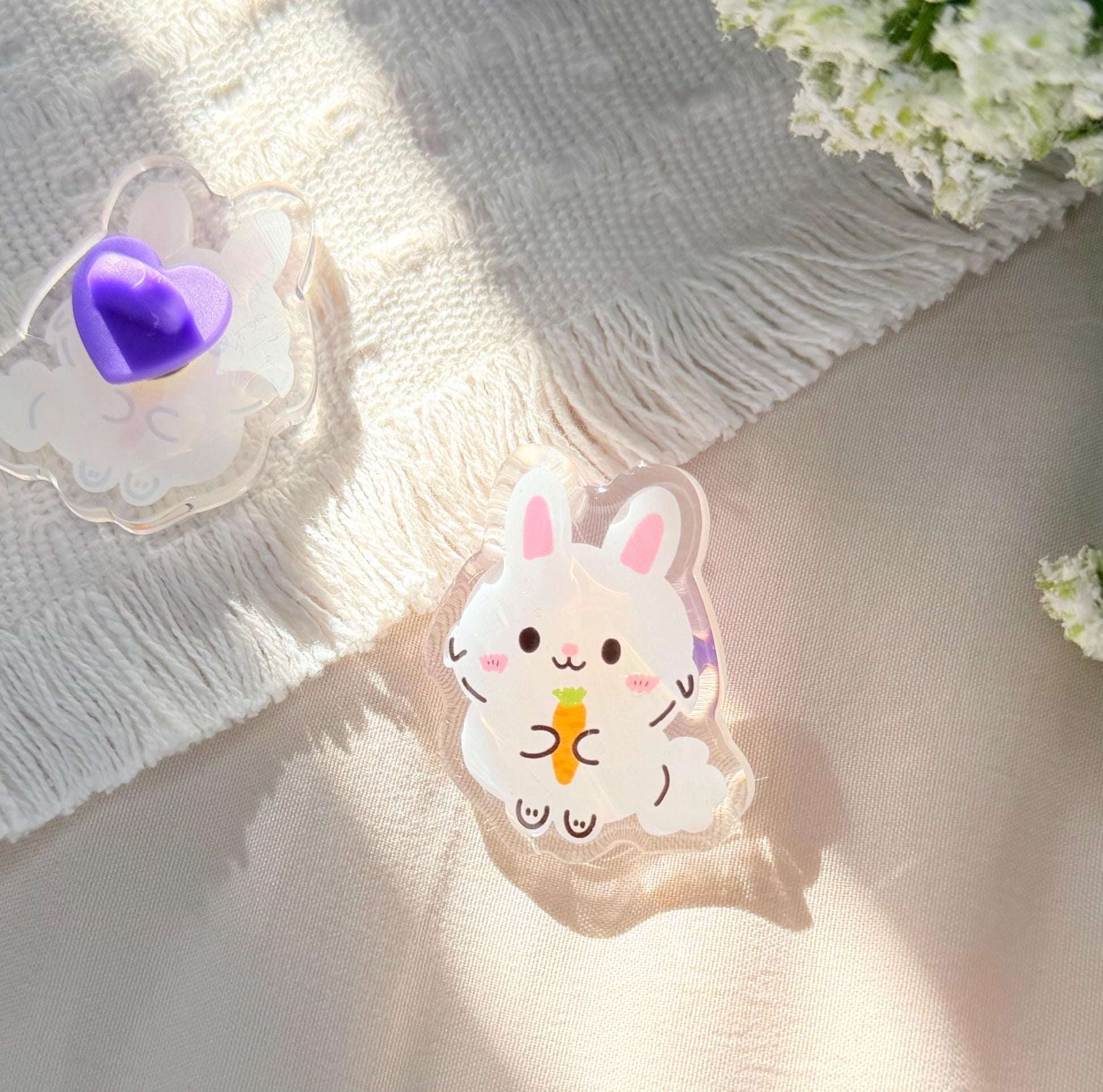 An acrylic pen of a cute Kawaii style white Easter bunny holding a carrot